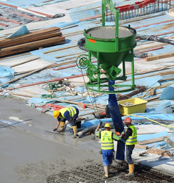 Rear view of people working in water