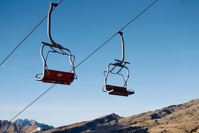 Low angle view of overhead cable car against sky