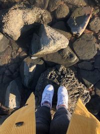 Low section of person standing on rock