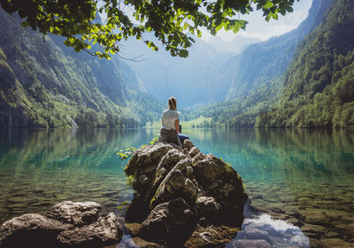 Man looking at lake against mountain