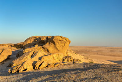 Rock formations in desert against clear sky