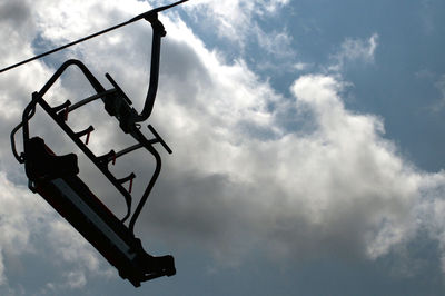 Low angle view of silhouette sign against sky