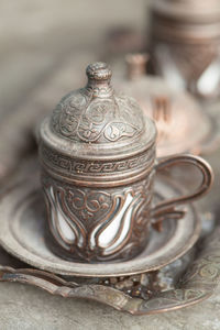 Close-up of antique cup on table