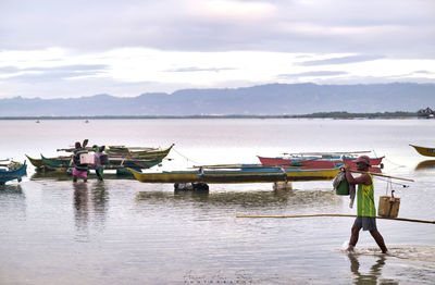 Man standing on boat against sky