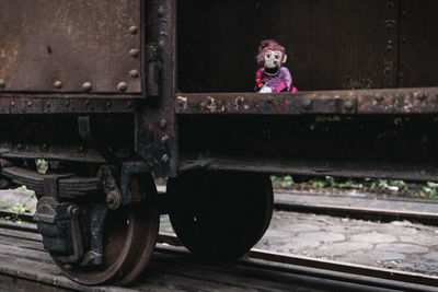 Side view of toy train sitting on railroad track