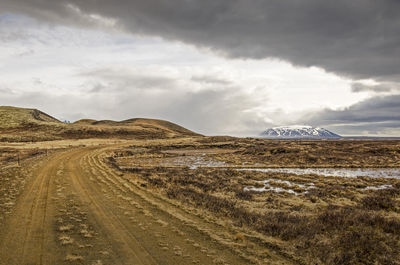 Dirt road under a dramatic sky in iceland