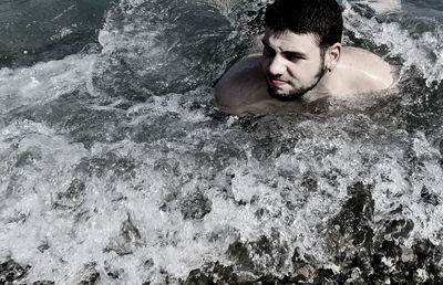 High angle view of man swimming in sea