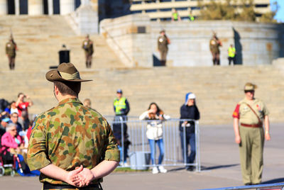 Rear view of soldier standing in city