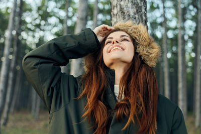 Close-up of smiling woman looking up