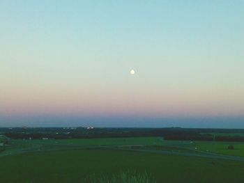 Scenic view of field against clear sky at night