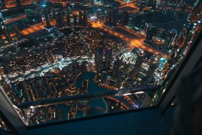 High angle view of city lit up at night