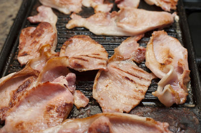 High angle view of bacon on barbecue grill