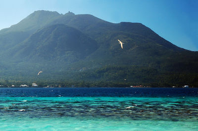 Scenic view of sea against mountain range