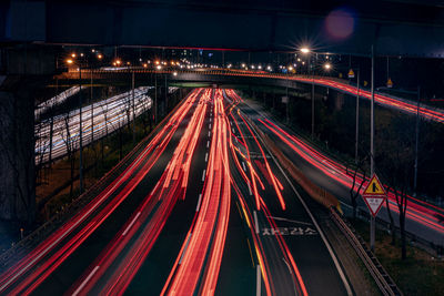 High angle view of light trails on highway at night