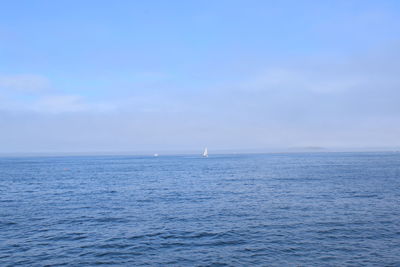 Sailboat in sea against sky