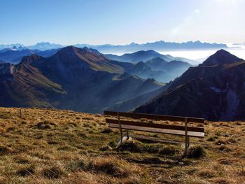 Scenic view of mountains against blue sky