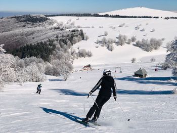People skiing on snow covered mountain
