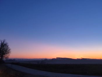 Scenic view of silhouette landscape against clear sky during sunset