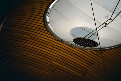 Low angle view of electric lamp hanging on ceiling