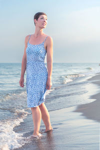 Young woman standing at beach