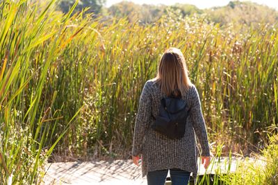 Rear view of woman standing on field