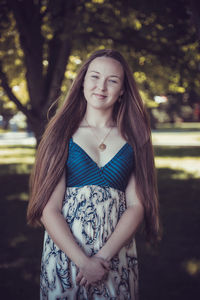 Caucasian woman happy running in summer or spring city park joyful and smiling in sundress 