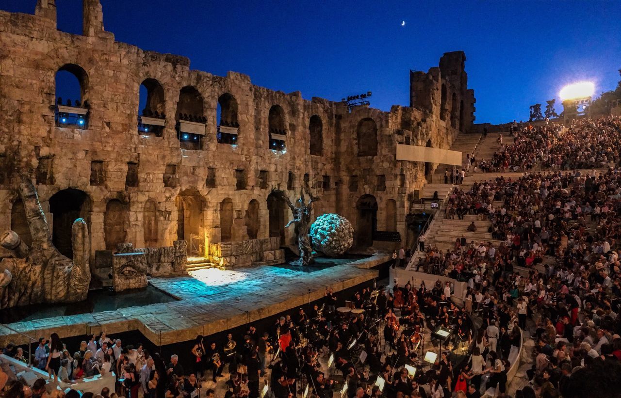 architecture, large group of people, built structure, building exterior, night, history, illuminated, outdoors, real people, clear sky, blue, crowd, sky, people