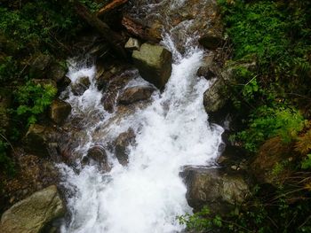 Scenic view of river flowing through rocks