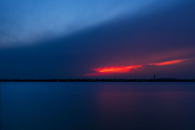 Scenic view of sea against romantic sky at sunset