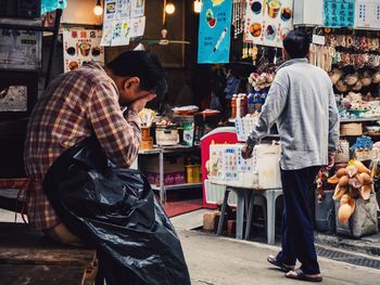 Men at market stall