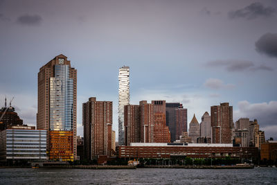 Cityscape of manhattan from hudson river at sunset. new york city, usa