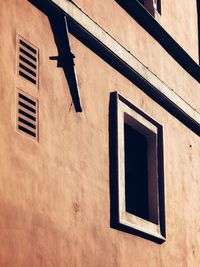 Low angle view of window on wall