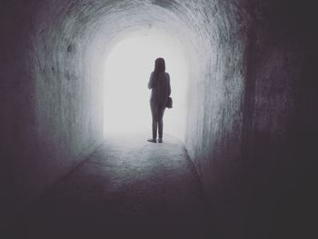 Silhouette of man walking on street