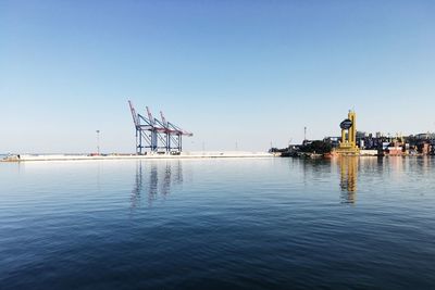 Ship moored at harbor against clear sky