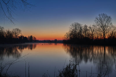 Scenic view of lake against sky during sunset