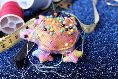 Close-up of pin cushion on fabric