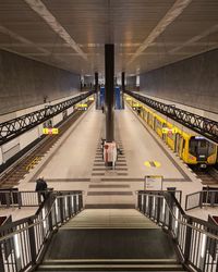 High angle view of man walking on escalator