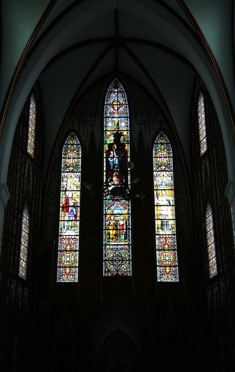 LOW ANGLE VIEW OF GLASS WINDOW IN TEMPLE