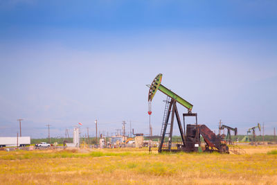 Traditional windmill on field against clear sky