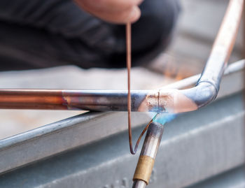 Close-up of person working on wood