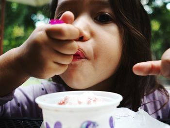 Close-up of young woman eating ice cream