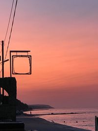 Scenic view of sea against orange sky