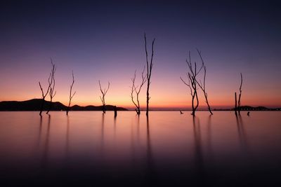 Scenic view of lake against sky at sunset