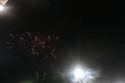 Low angle view of firework display at night