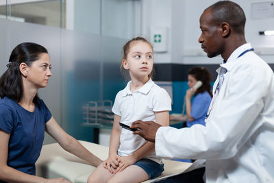 Doctor talking with patients mother at hospital