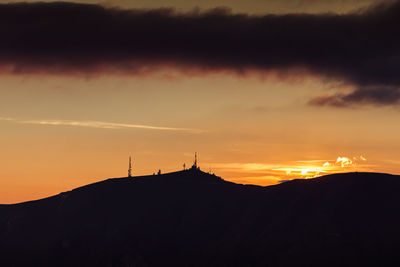 Tv antennas with dolomitic background silhouette from monte pizzoc summit, veneto, italy