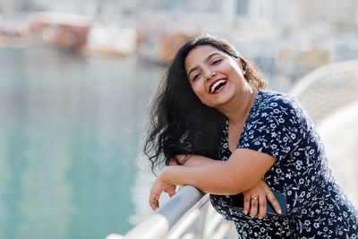 Portrait of a laughing indian woman while walking around the city. positive emotions, cheerful girl.