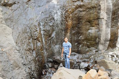 Boy standing on rock