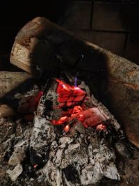 Close-up of firewood on log at night