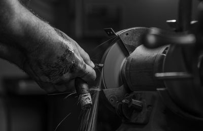 Cropped hand of man working at workshop